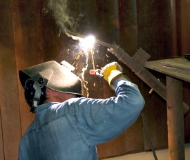 person welding metal tube